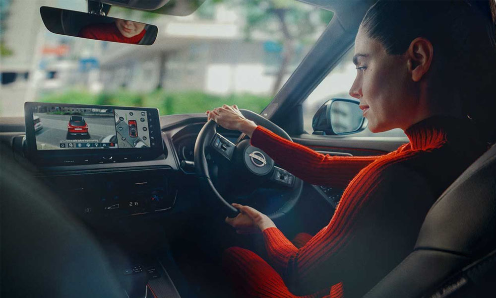 A woman viewing the the 3d around view monitor in a Nissan