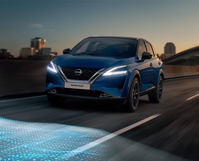 Blue SUV with lights on driving at night